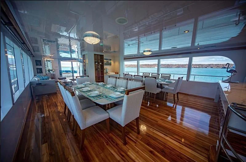a large room with a table and chairs aboard GRAND DAPHNE Yacht for Charter