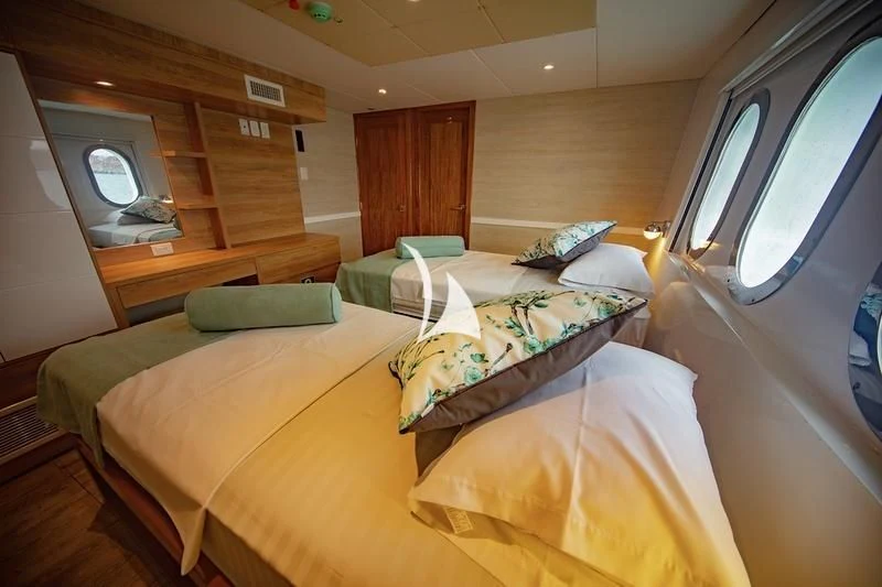 a room with a bed and a television aboard GRAND DAPHNE Yacht for Charter