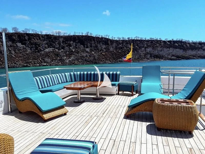 a deck with chairs and a table on it aboard GRAND DAPHNE Yacht for Charter