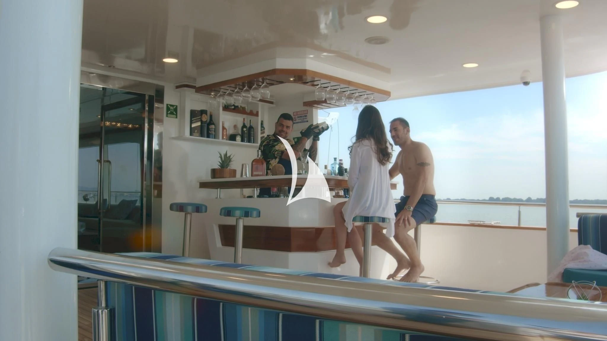 a group of people standing on a white table in a room aboard GRAND DAPHNE Yacht for Charter