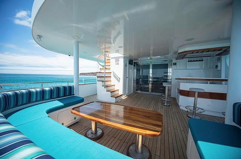 a room with a table and chairs aboard GRAND DAPHNE Yacht for Charter