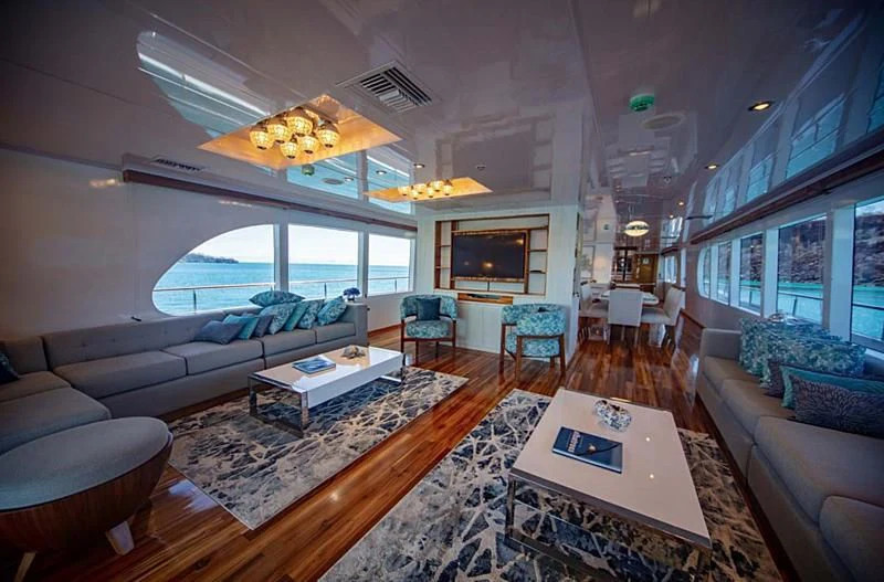 a living room with a large window aboard GRAND DAPHNE Yacht for Charter