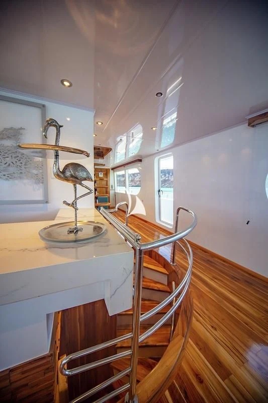 a kitchen with a table and chairs aboard GRAND DAPHNE Yacht for Charter