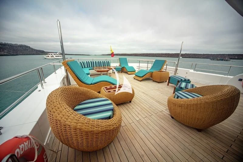 a deck with chairs and a boat on it aboard GRAND DAPHNE Yacht for Charter