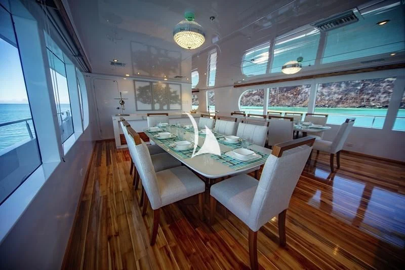 a room with a table and chairs aboard GRAND DAPHNE Yacht for Charter