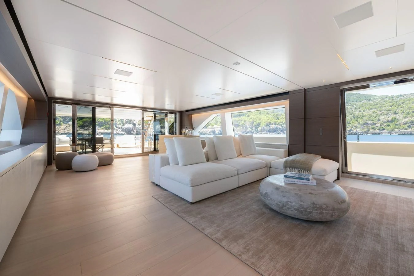 a modern living room with a large glass wall aboard PALOMA Yacht for Sale