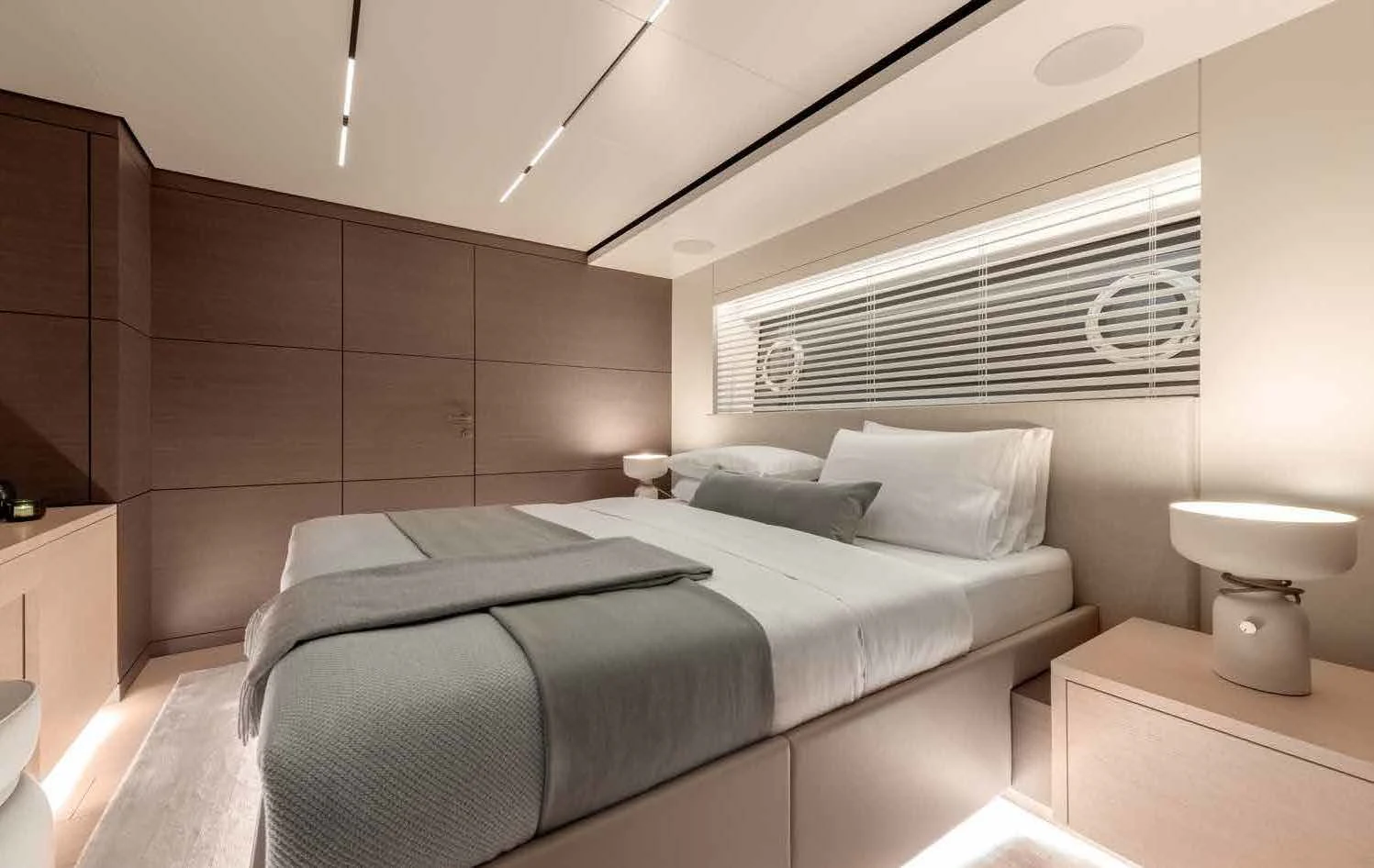 a room with a bed and a lamp aboard PALOMA Yacht for Sale