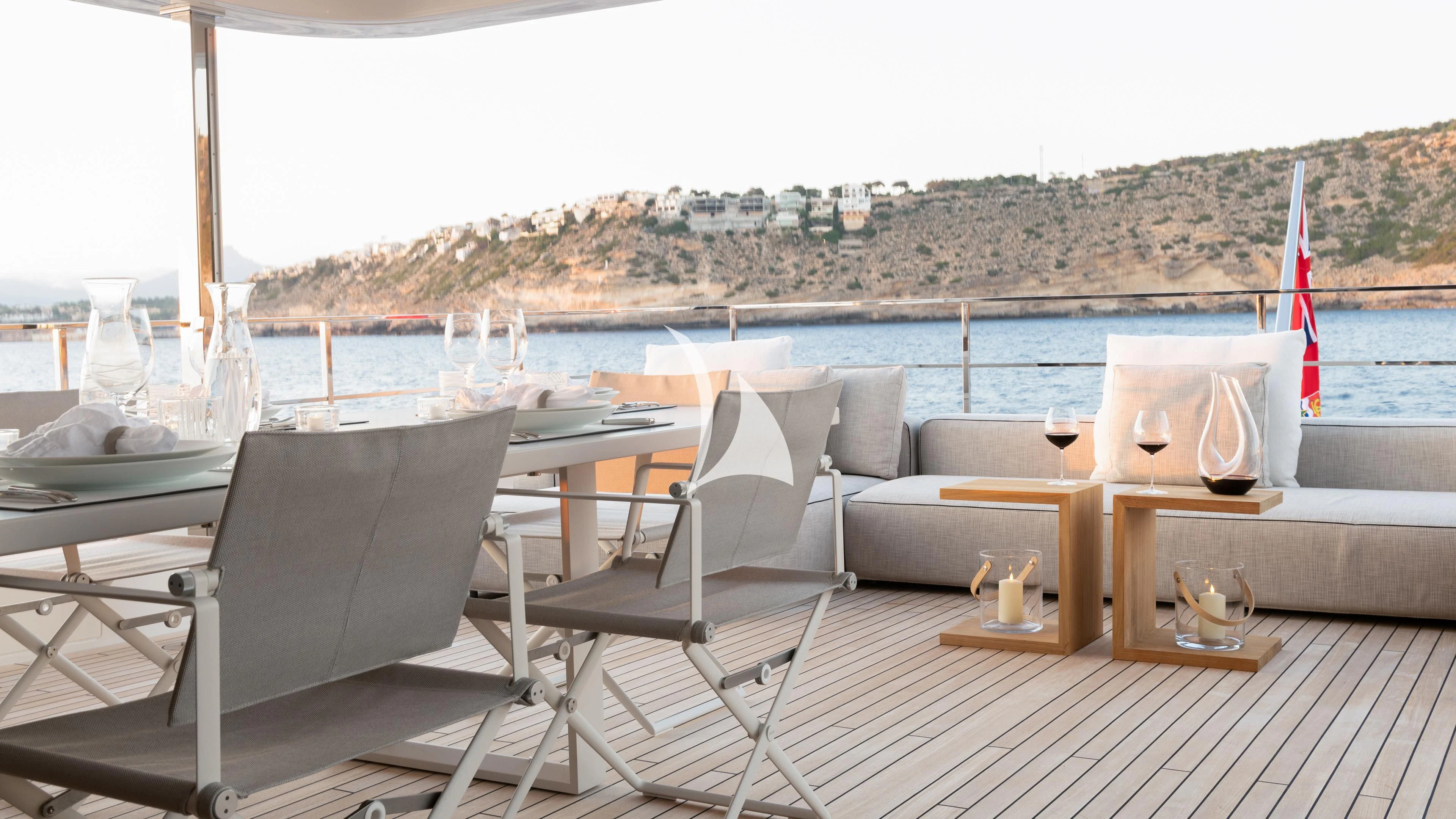 a deck with chairs and a table on it aboard PALOMA Yacht for Sale