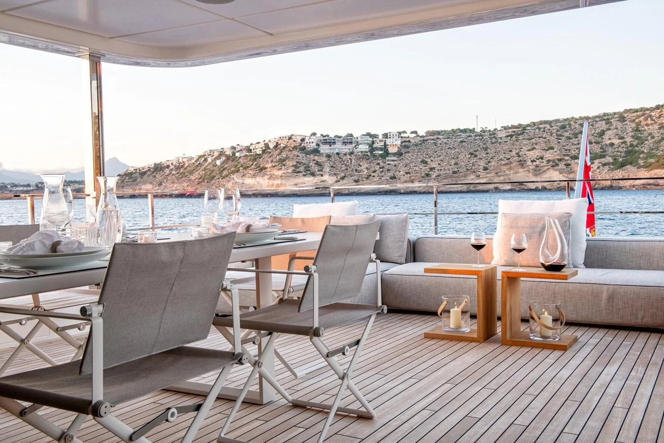 a deck with chairs and a table on it aboard PALOMA Yacht for Sale