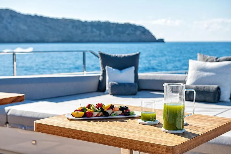 a table with food and drinks on it aboard PALOMA Yacht for Sale