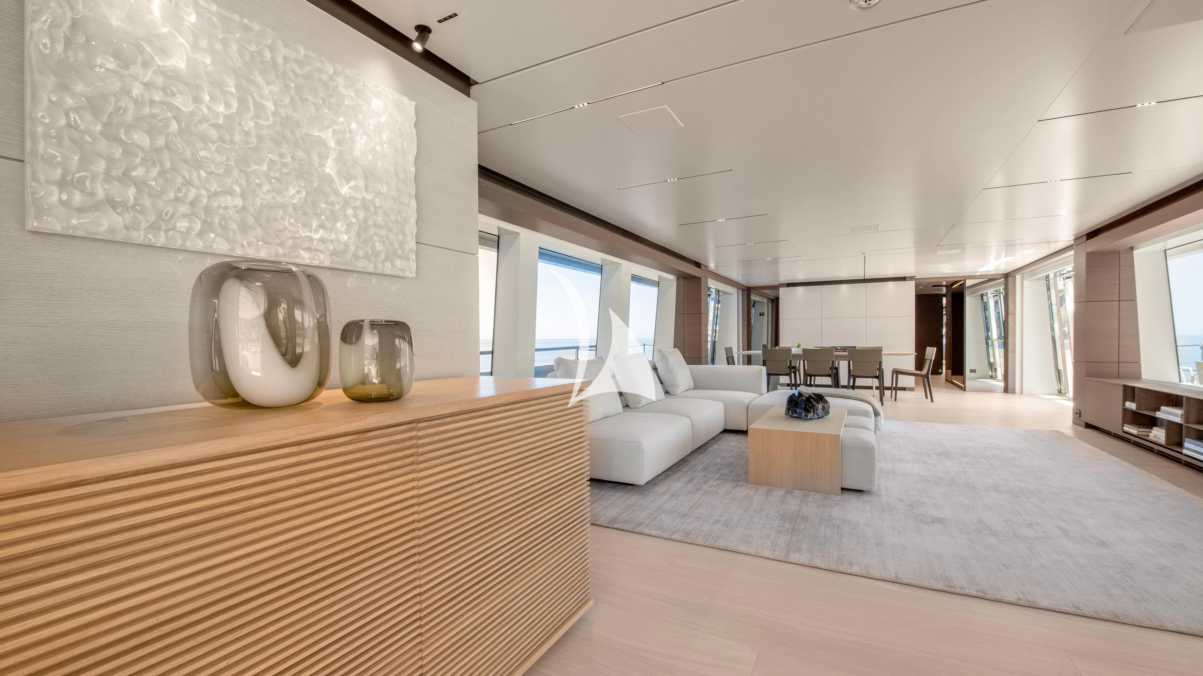 a large living room with white furniture aboard PALOMA Yacht for Sale