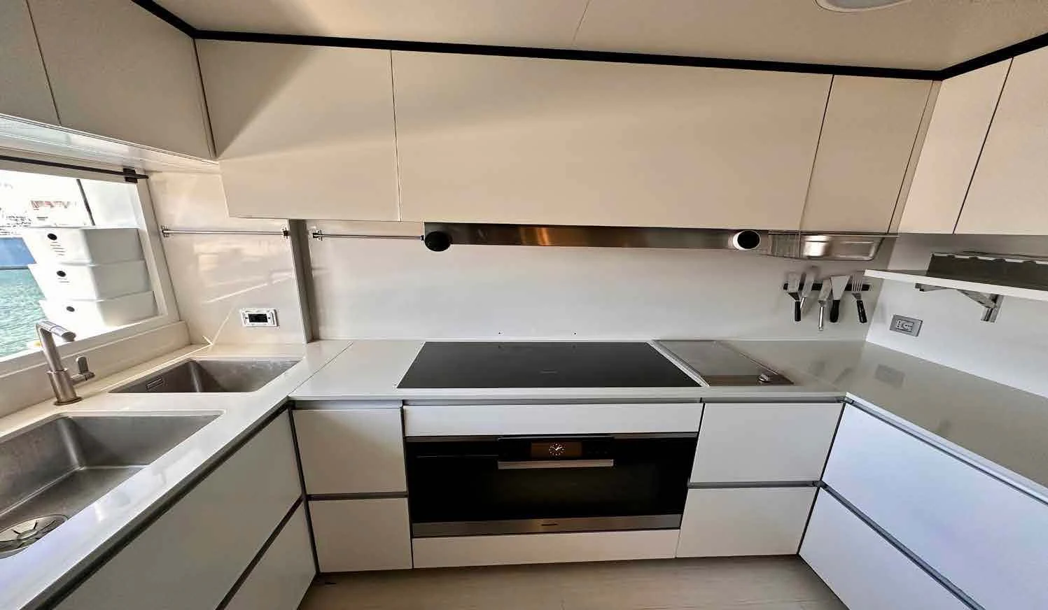 a kitchen with white cabinets aboard PALOMA Yacht for Sale