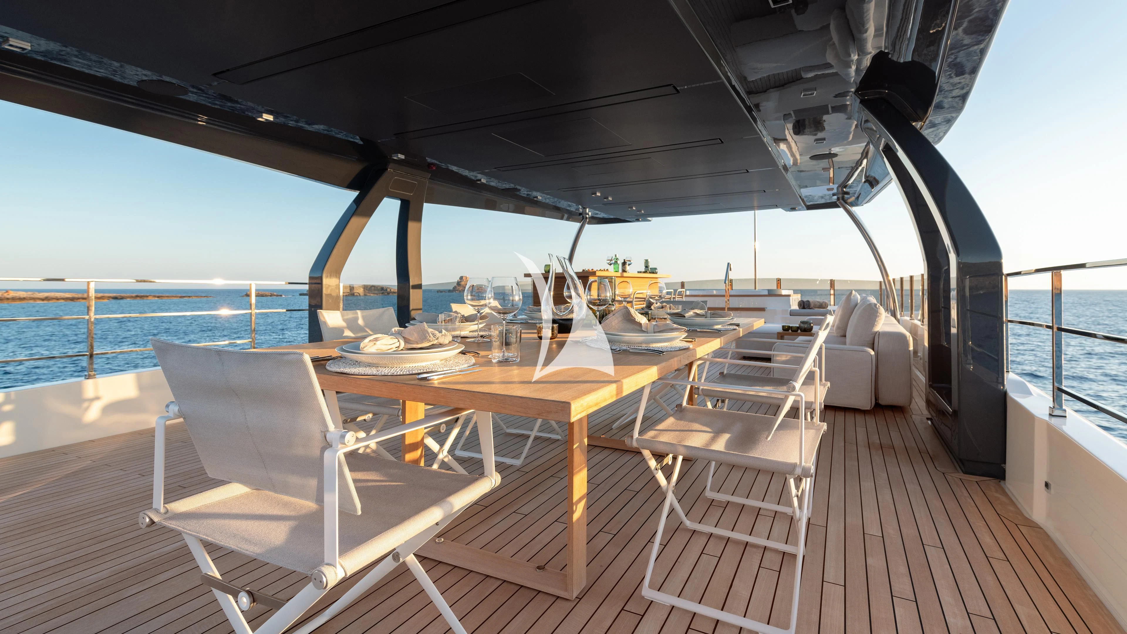 a deck with a table and chairs on it aboard PALOMA Yacht for Sale