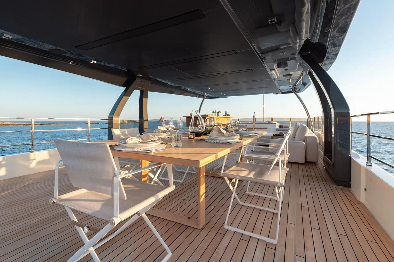 a deck with a table and chairs on it aboard PALOMA Yacht for Sale