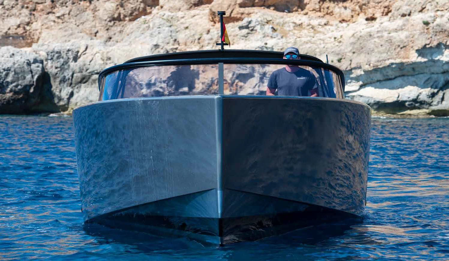 a man driving a boat aboard PALOMA Yacht for Sale