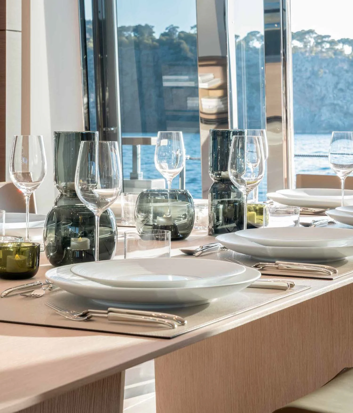 a table with wine glasses and plates aboard PALOMA Yacht for Sale