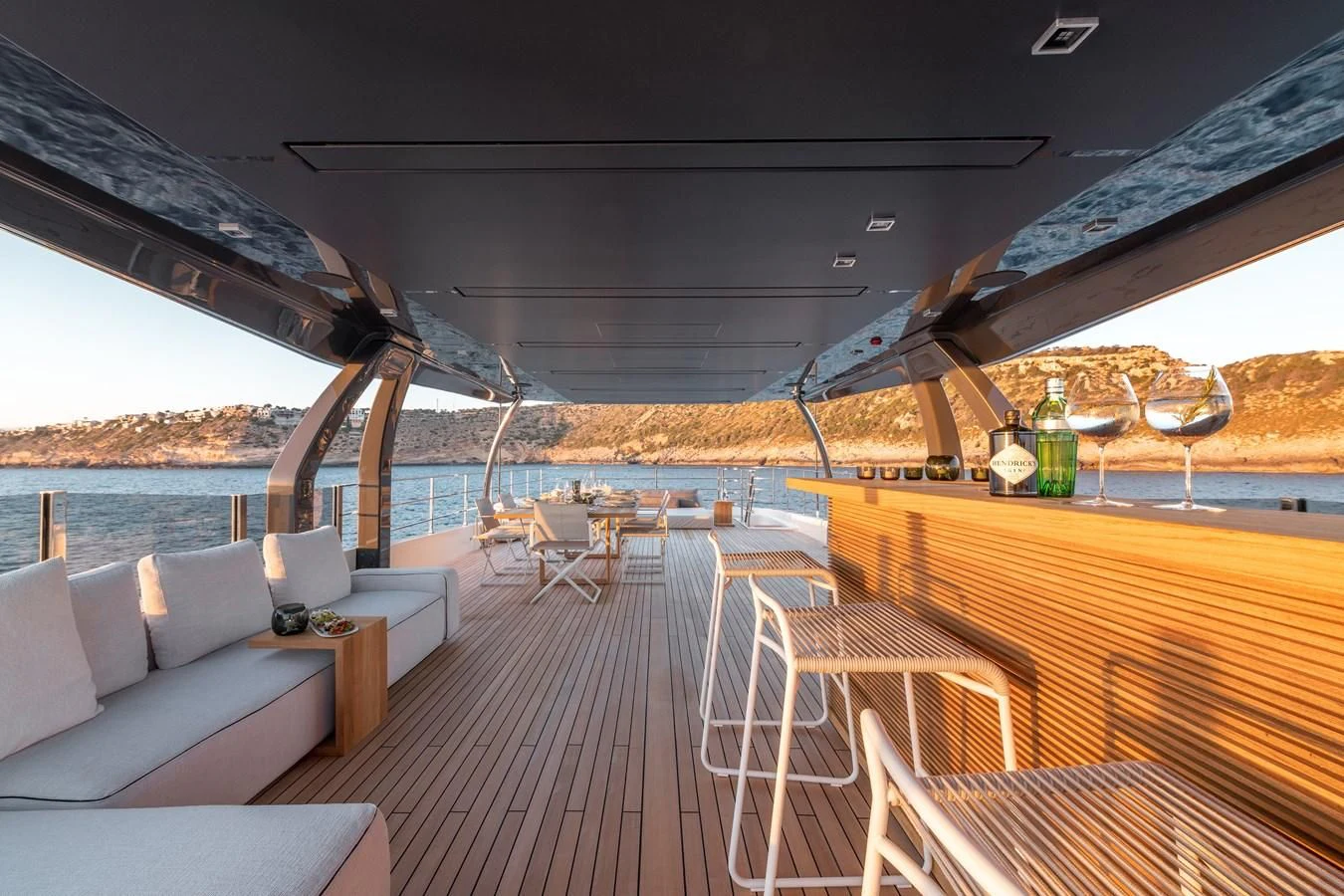 a deck with a view of the ocean and the beach aboard PALOMA Yacht for Sale