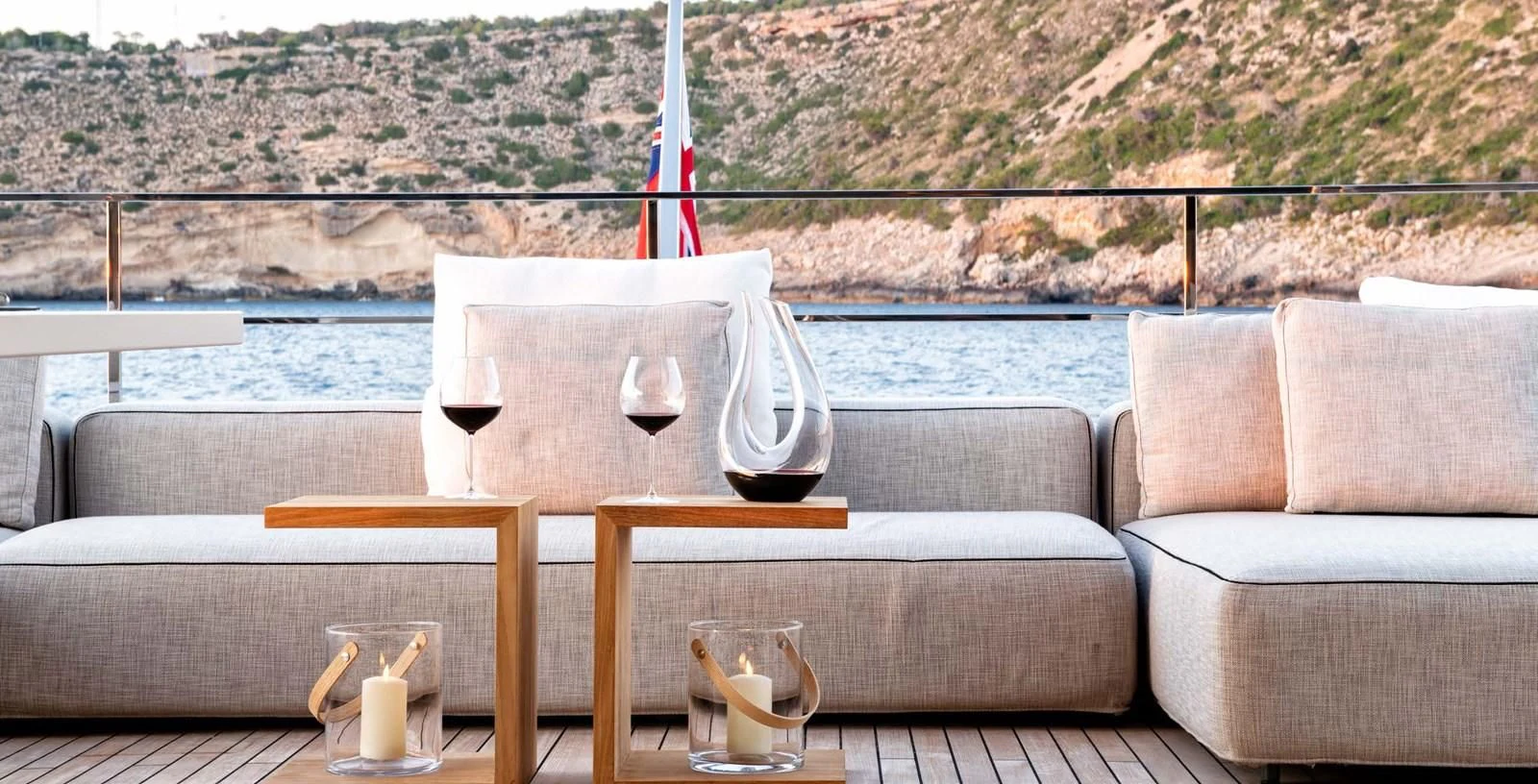 a table with glasses and a candle on it aboard PALOMA Yacht for Sale