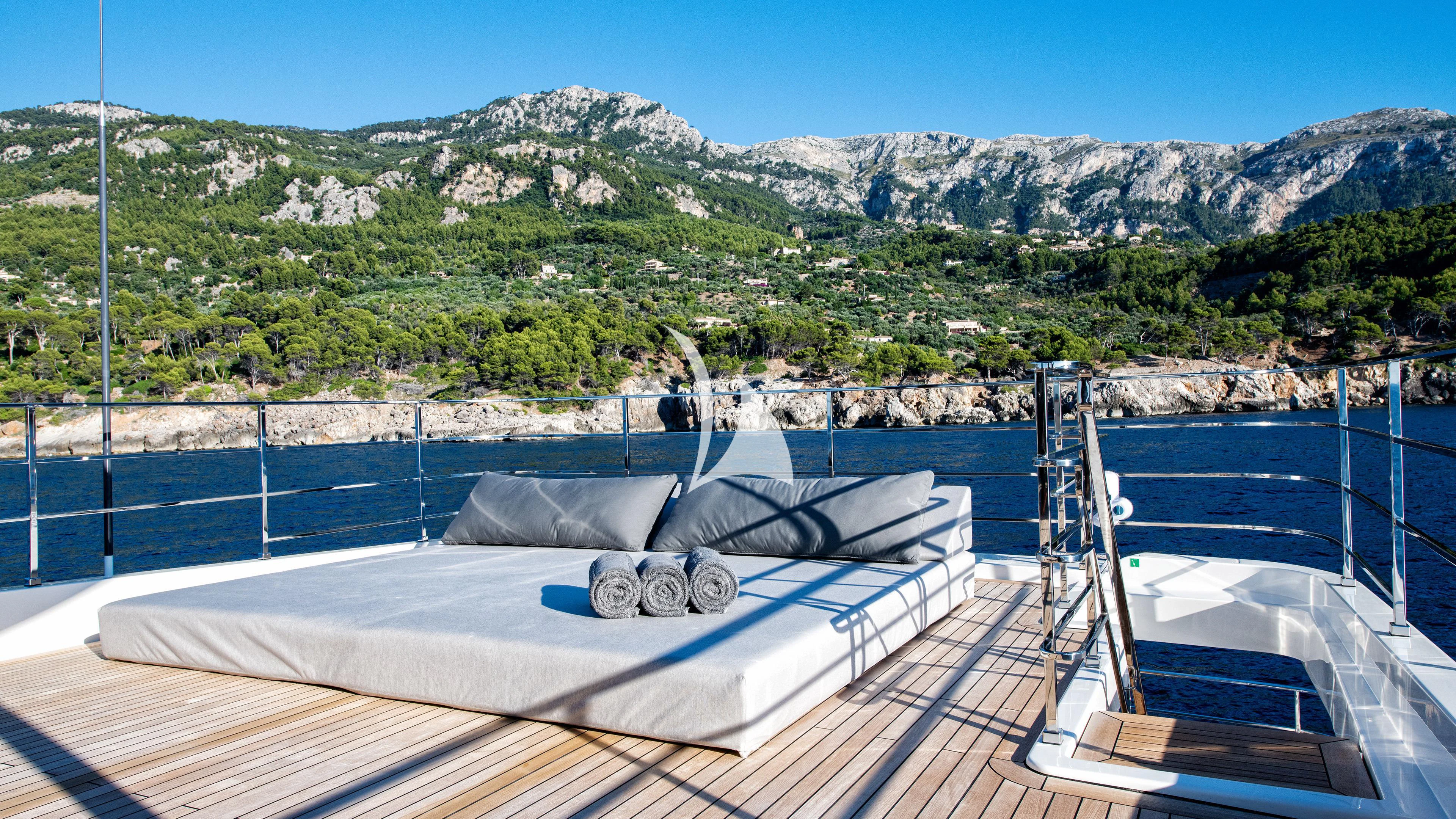 a large pool with a view of mountains in the background aboard PALOMA Yacht for Sale