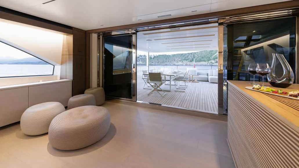 a room with a table chairs and a view of the ocean aboard PALOMA Yacht for Sale