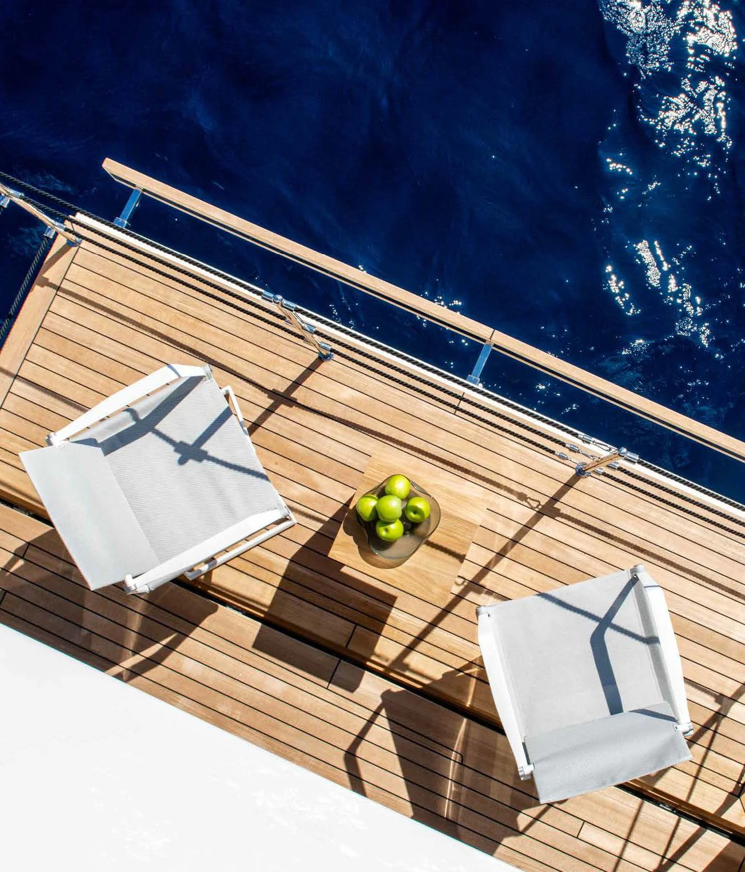 a deck with a chair and a table on it aboard PALOMA Yacht for Sale