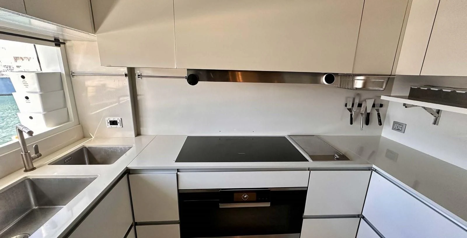 a kitchen with white cabinets aboard PALOMA Yacht for Sale