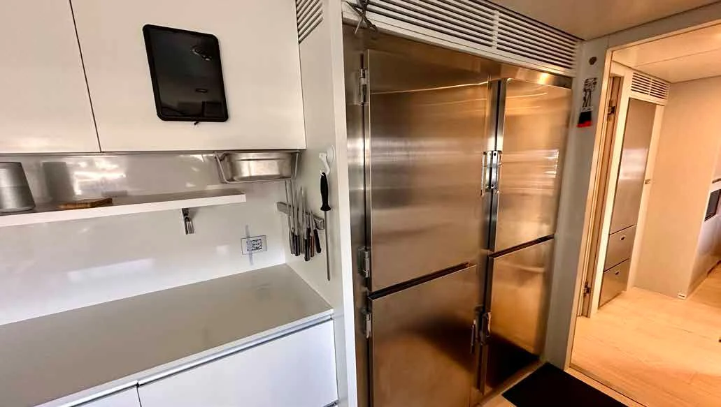 a kitchen with a stainless steel refrigerator aboard PALOMA Yacht for Sale