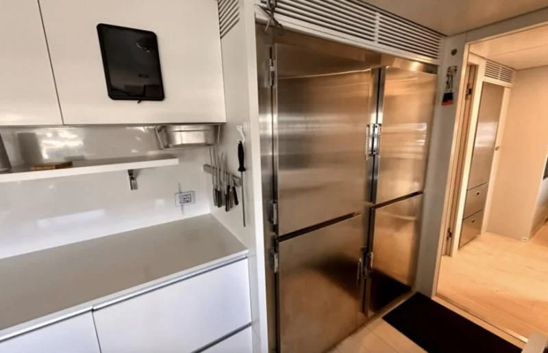 a kitchen with a stainless steel refrigerator aboard PALOMA Yacht for Sale