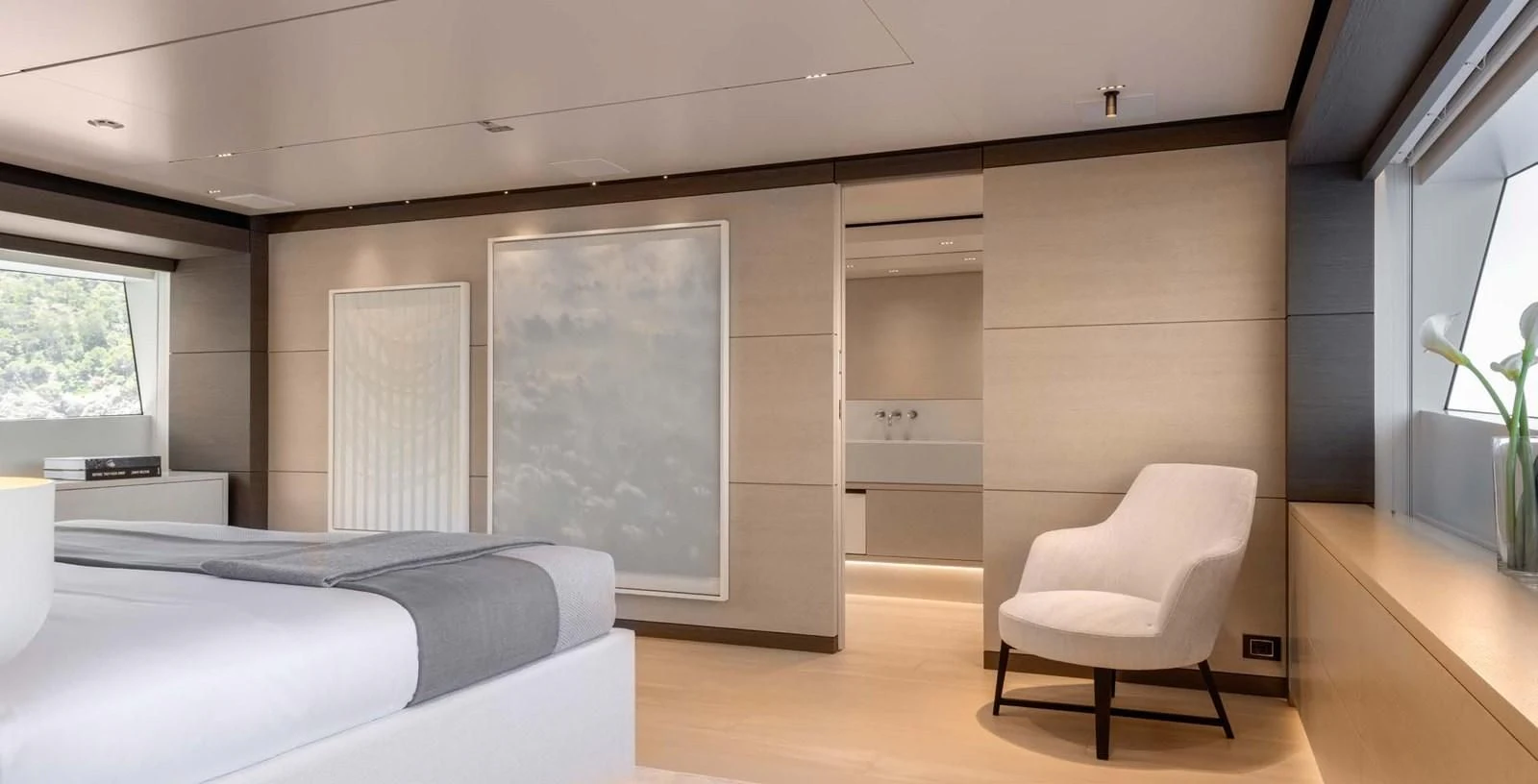 a room with a bed and a chair aboard PALOMA Yacht for Sale