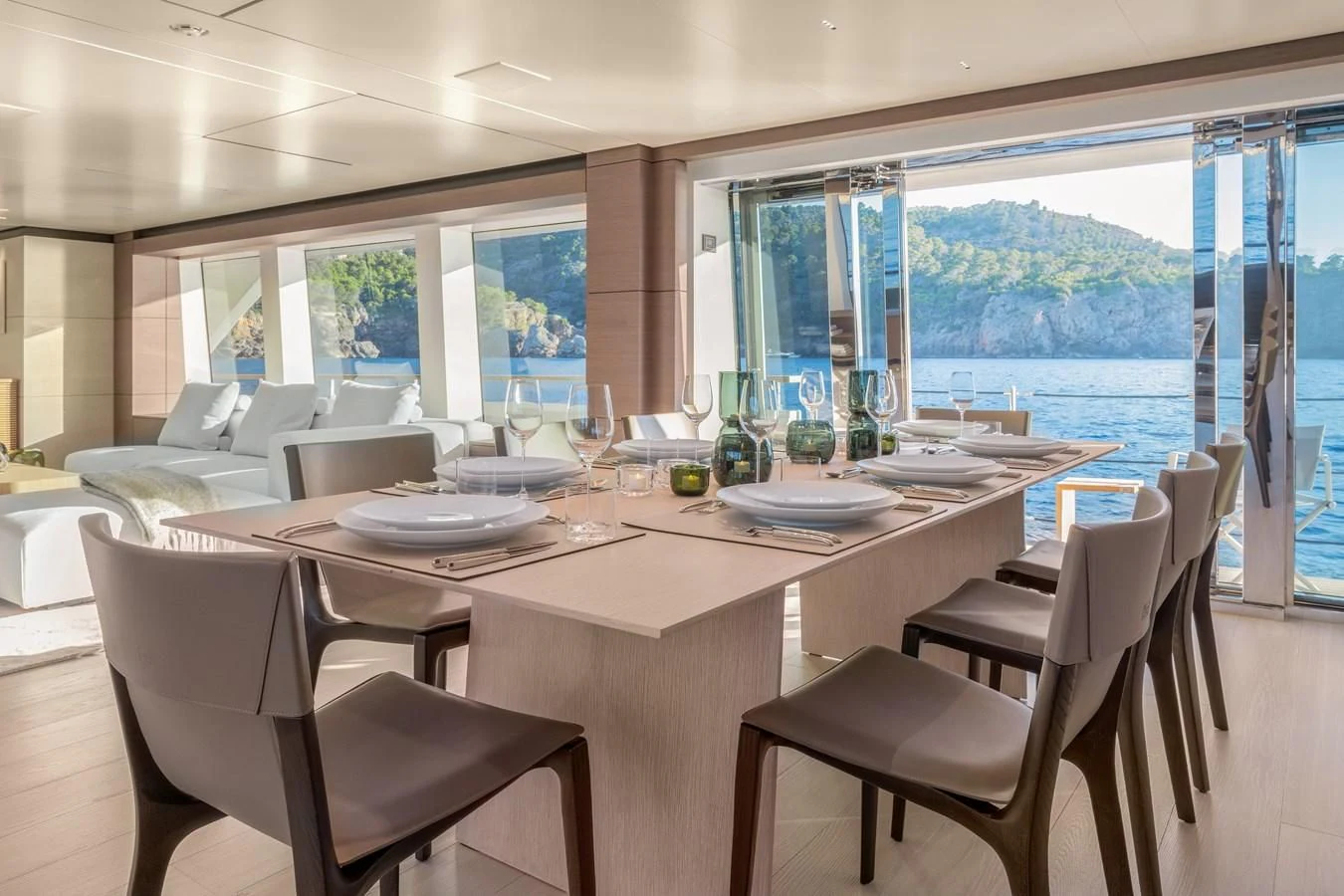 a large dining table with chairs and a large window overlooking a city aboard PALOMA Yacht for Sale
