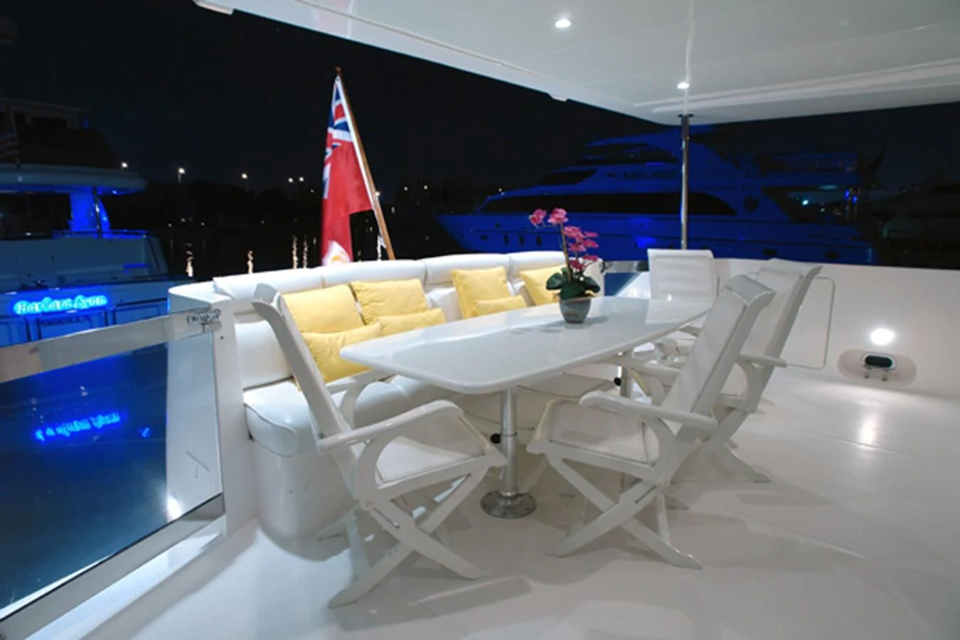 a table with chairs and a flag aboard SANTO ANTONIO Yacht for Sale