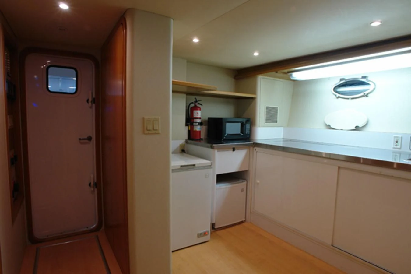 a kitchen with a microwave oven and a refrigerator aboard SANTO ANTONIO Yacht for Sale