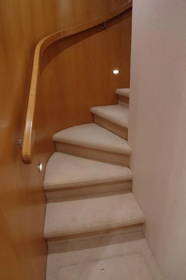 a staircase with a wood railing aboard SANTO ANTONIO Yacht for Sale