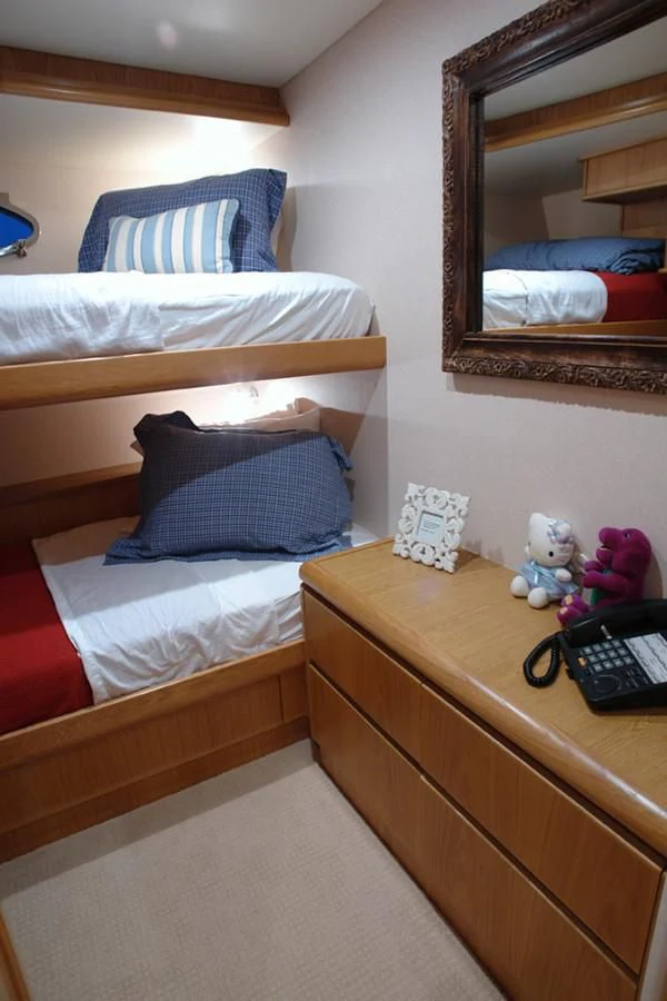 a bed with a mirror and stuffed animals on it aboard SANTO ANTONIO Yacht for Sale