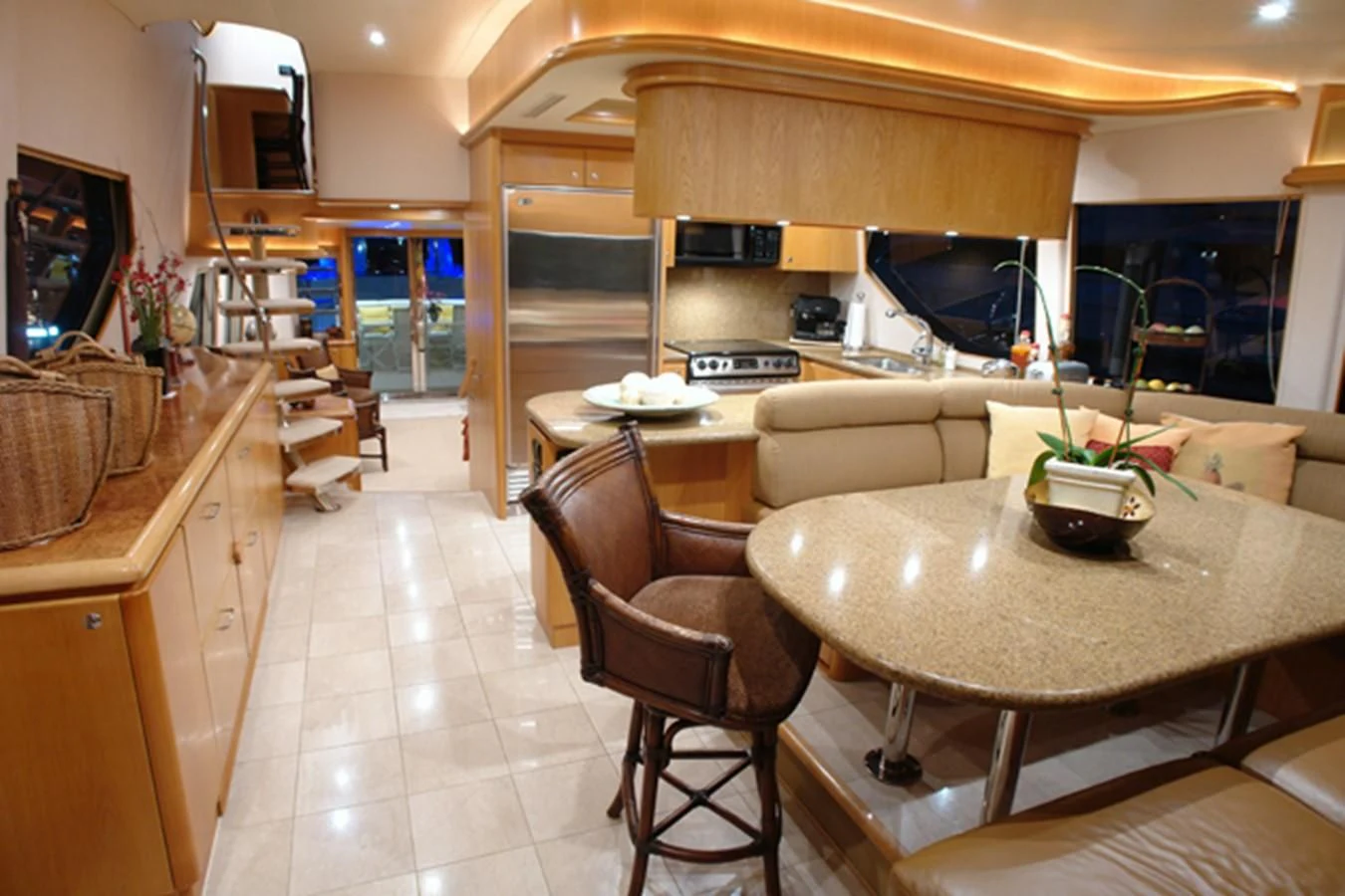 a kitchen with a table and chairs aboard SANTO ANTONIO Yacht for Sale