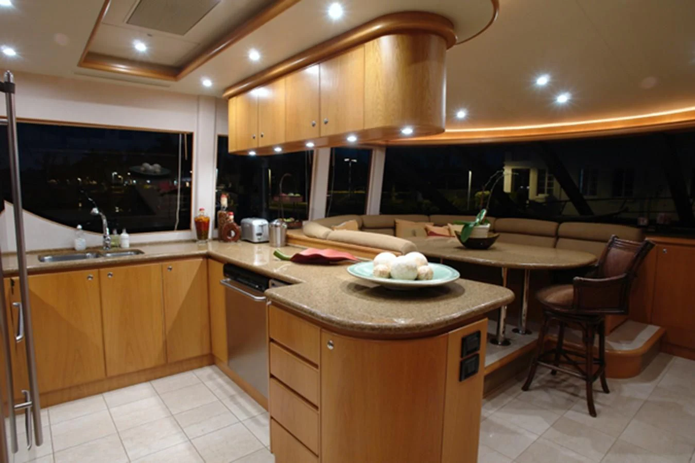 a kitchen with wooden cabinets aboard SANTO ANTONIO Yacht for Sale
