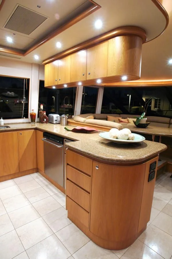 a kitchen with wooden cabinets aboard SANTO ANTONIO Yacht for Sale