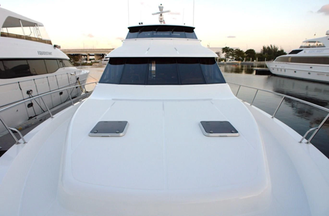 a white yacht in a harbor aboard SANTO ANTONIO Yacht for Sale