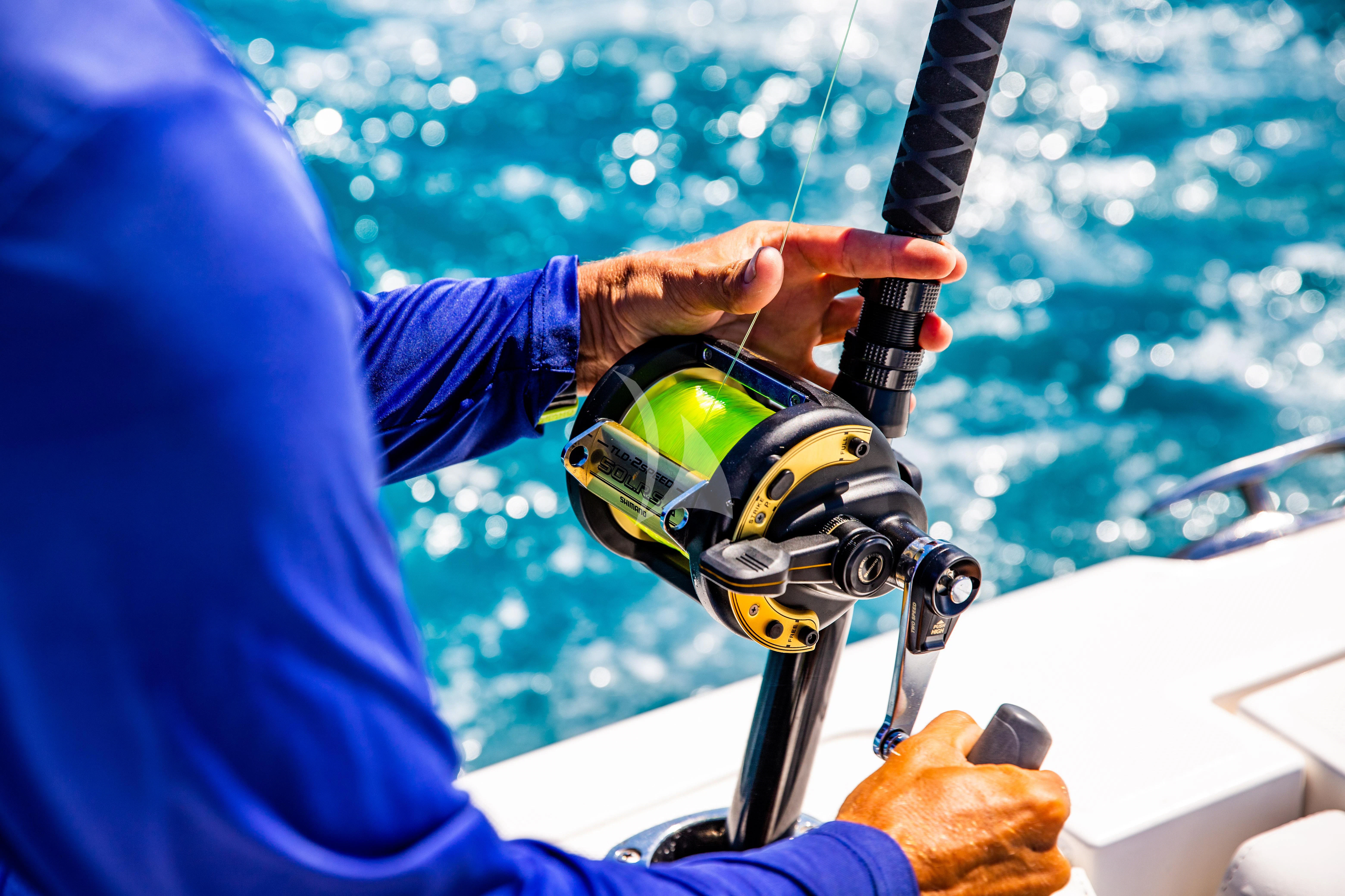 a person holding a fishing pole aboard SEAQUEST Yacht for Sale