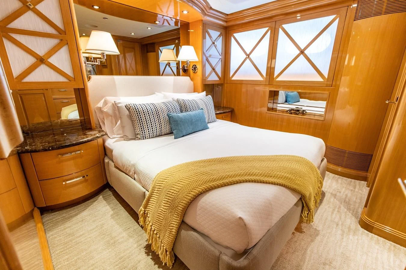 a bedroom with a bed and a dresser aboard SEAQUEST Yacht for Sale
