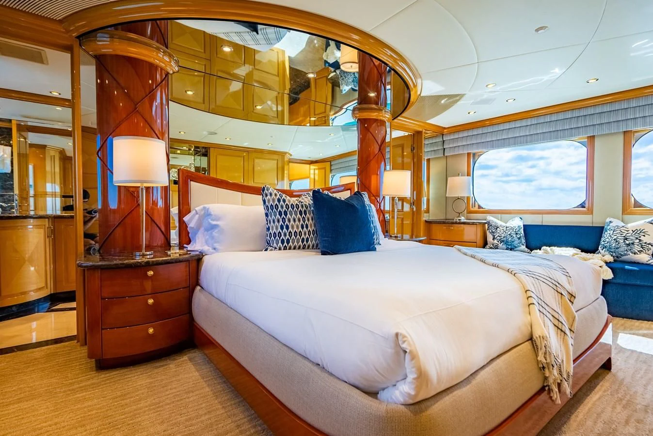 a bedroom with a large mirror aboard SEAQUEST Yacht for Sale