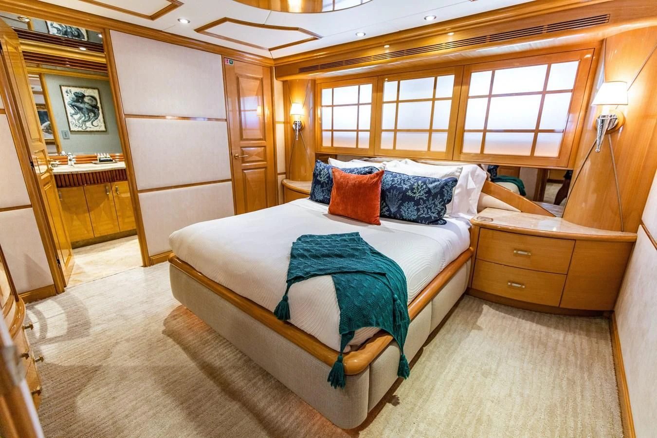a bedroom with a bed and a chair aboard SEAQUEST Yacht for Sale