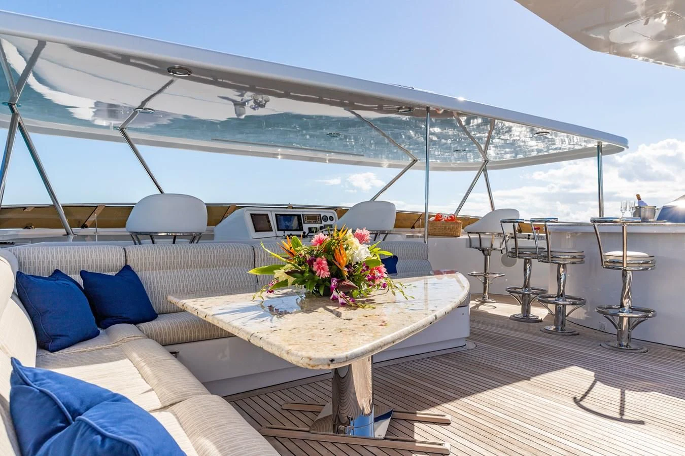 a large white tent with a table and chairs and a large white umbrella aboard SEAQUEST Yacht for Sale