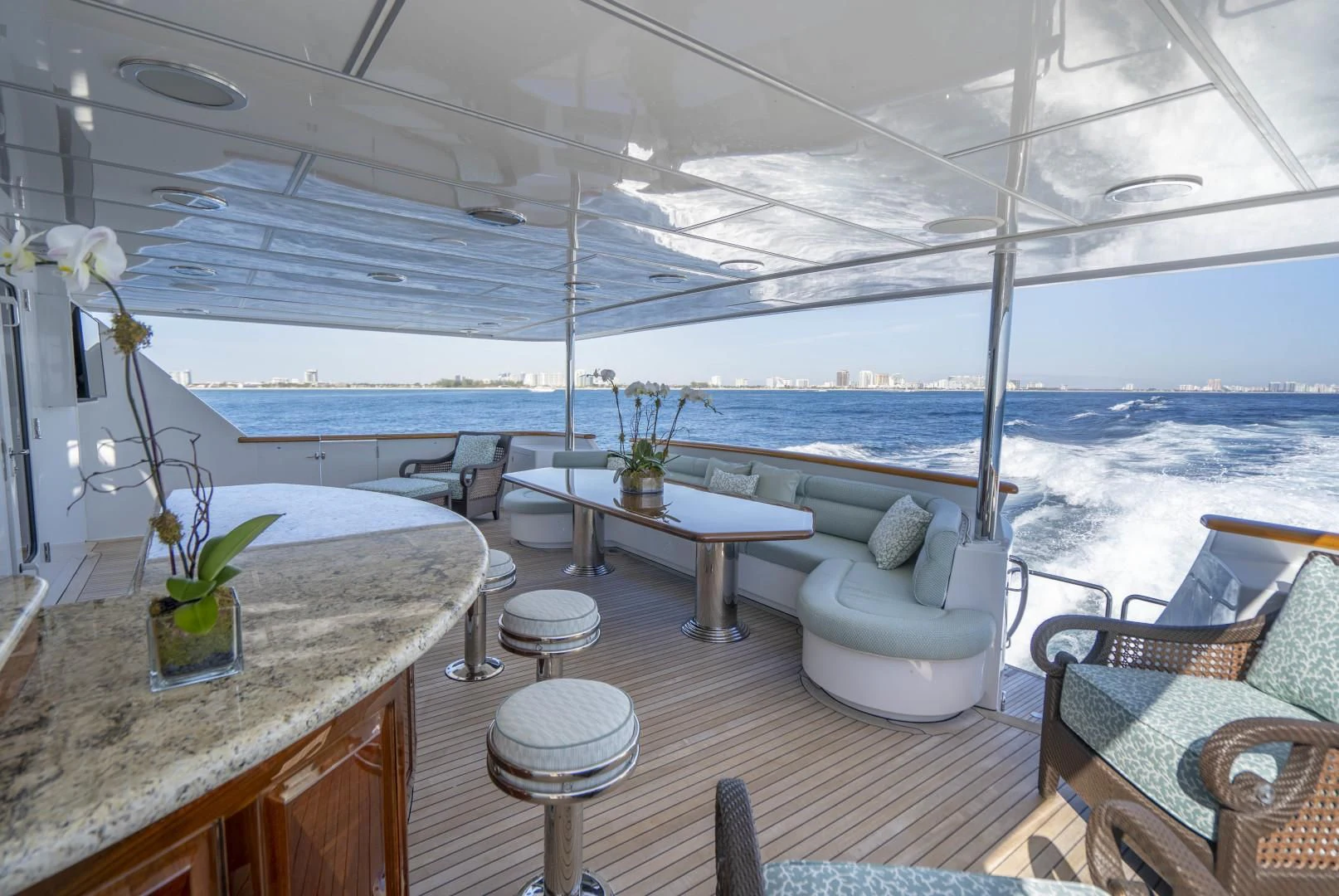 a room with a table chairs and plants on the table aboard SEAQUEST Yacht for Sale