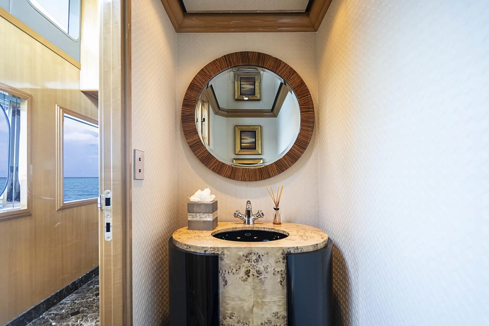 a bathroom with a round mirror aboard SEAQUEST Yacht for Sale
