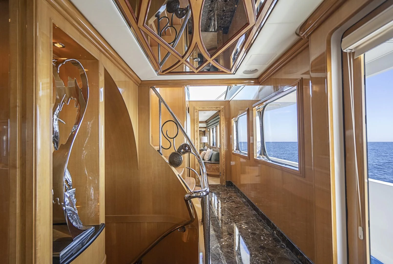 a room with a wood paneled wall and a window with a mirror aboard SEAQUEST Yacht for Sale