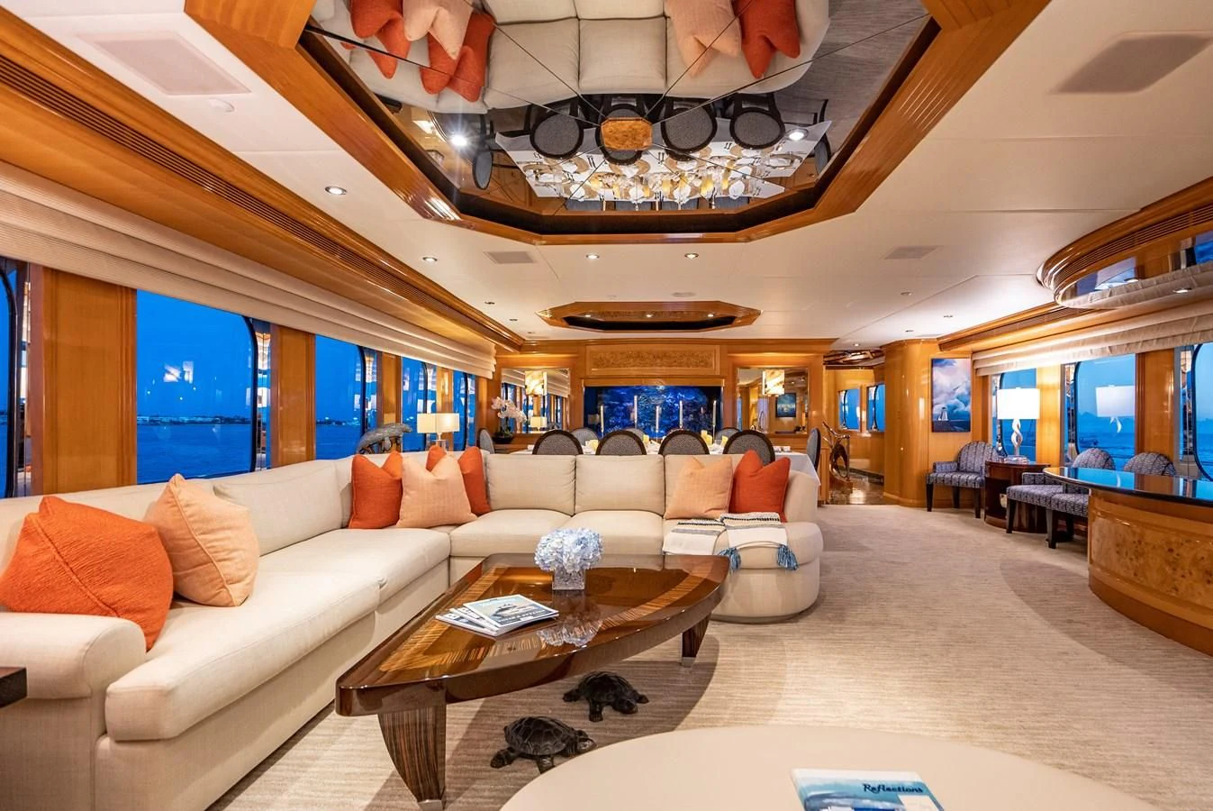 a living room with a chandelier aboard SEAQUEST Yacht for Sale
