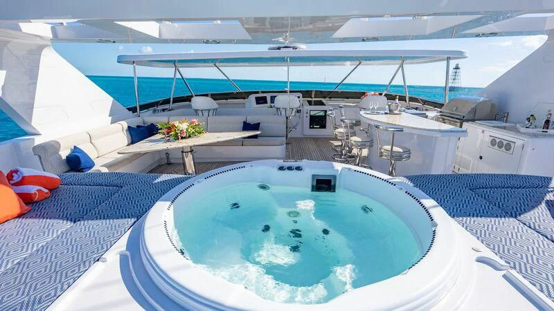 a swimming pool with a large white building in the background aboard SEAQUEST Yacht for Sale