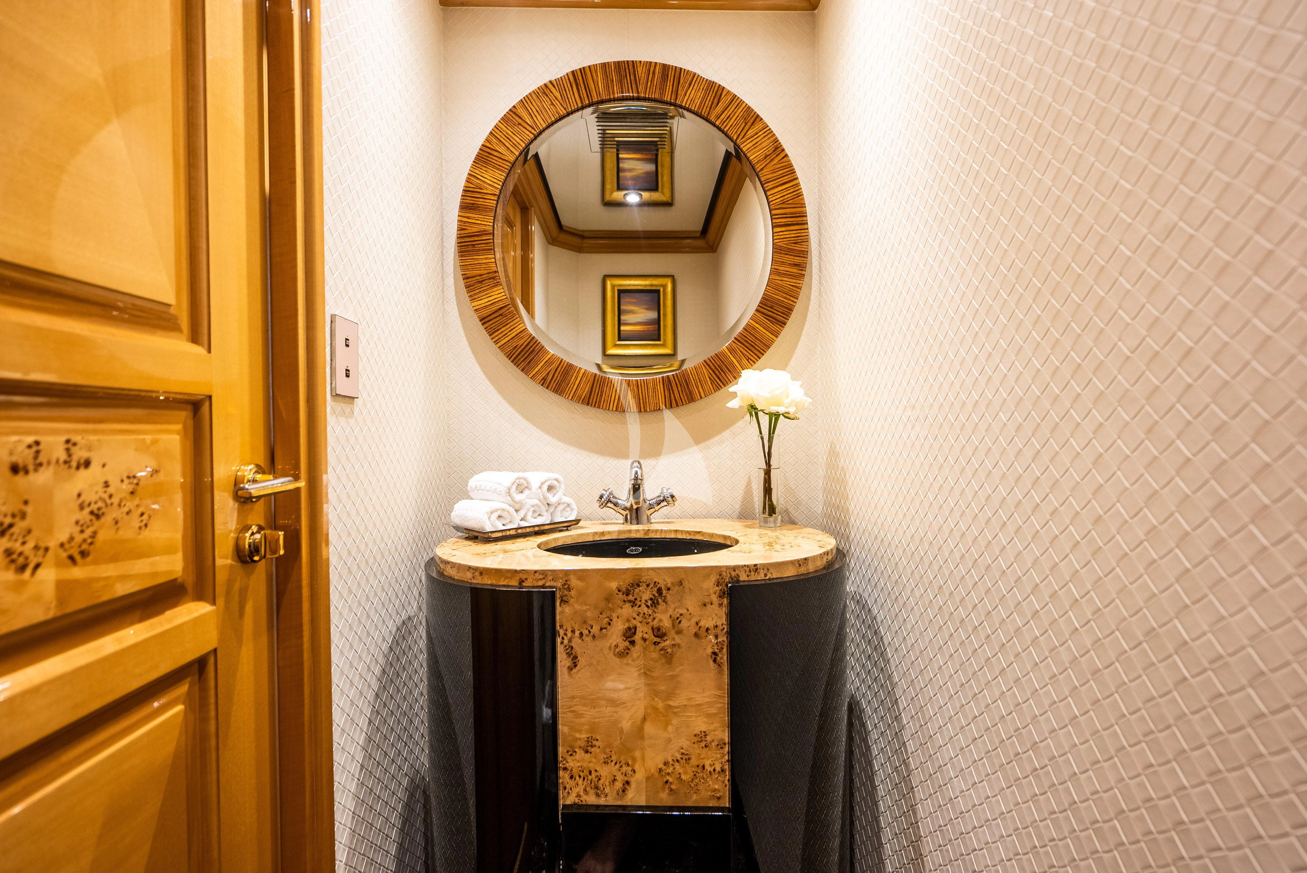 a bathroom with a mirror and a sink aboard SEAQUEST Yacht for Sale