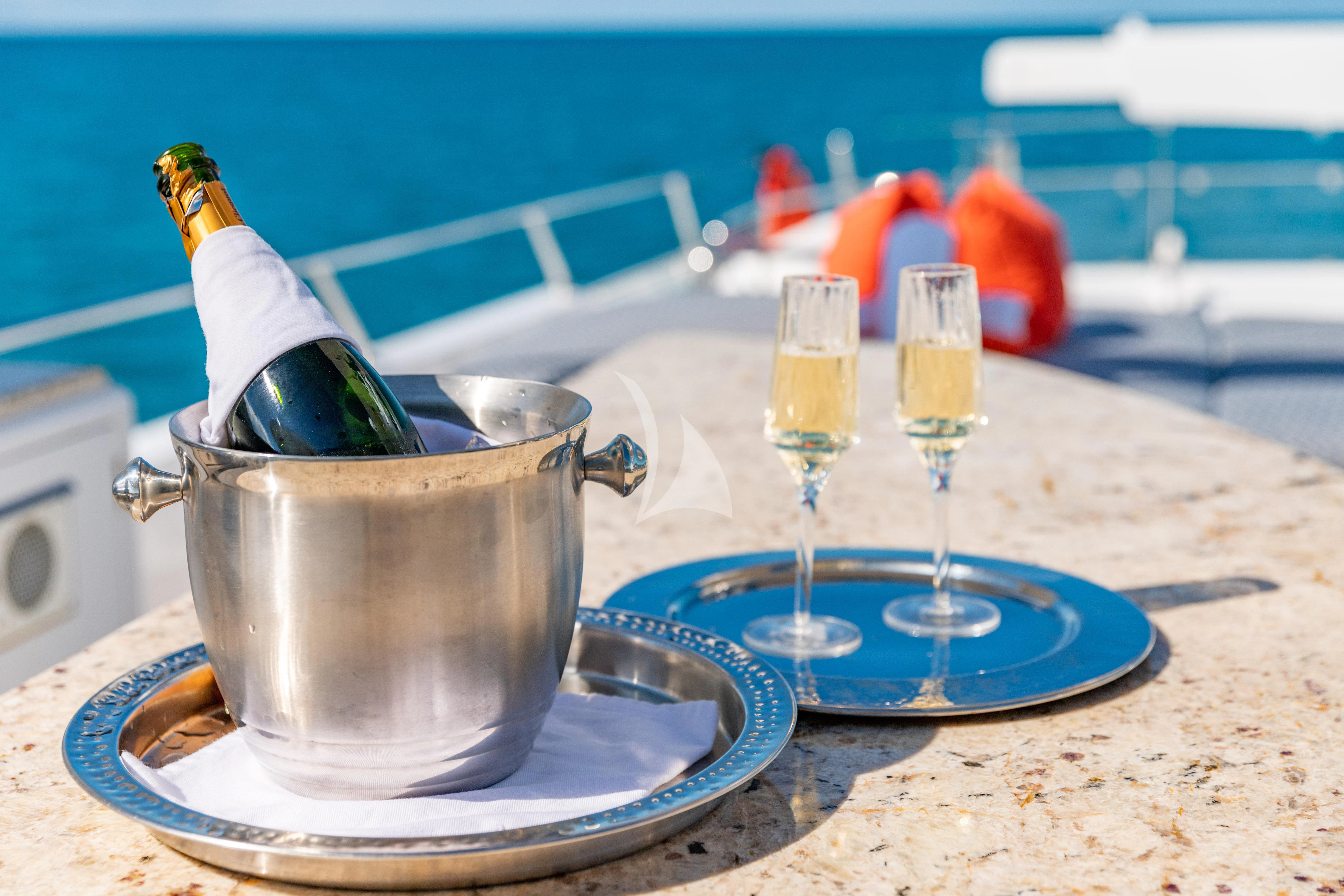 a bowl of liquid next to a glass with a bottle on it aboard SEAQUEST Yacht for Sale